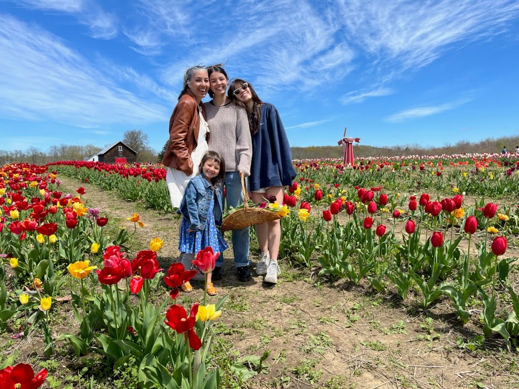 Melissa and her daughters in a tulip field